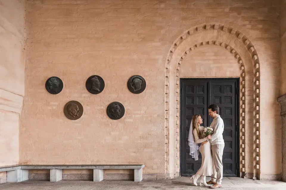 A wedding couple sharing a quiet moment by a doorway.