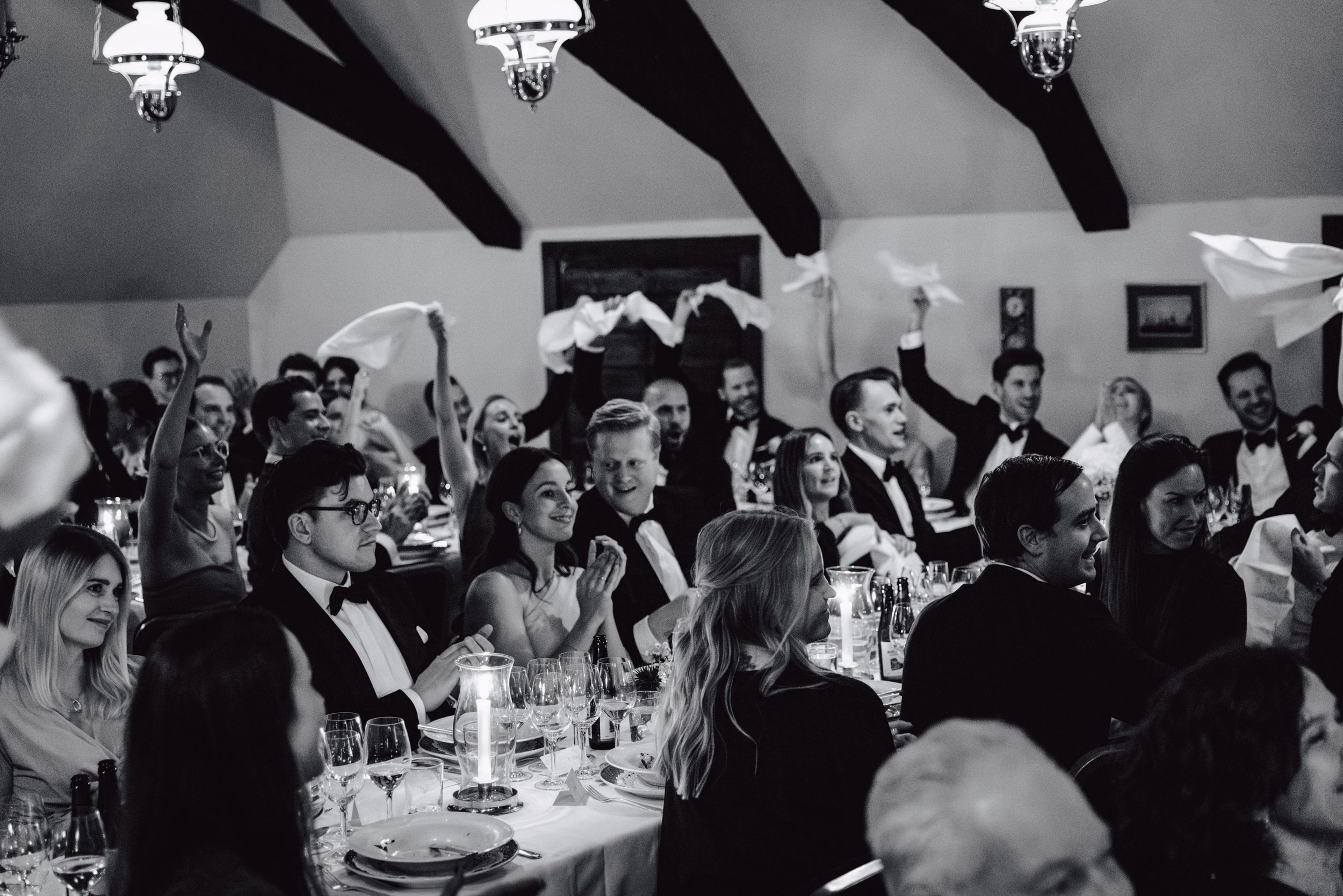 Wedding guests celebrating together during a black-and-white reception