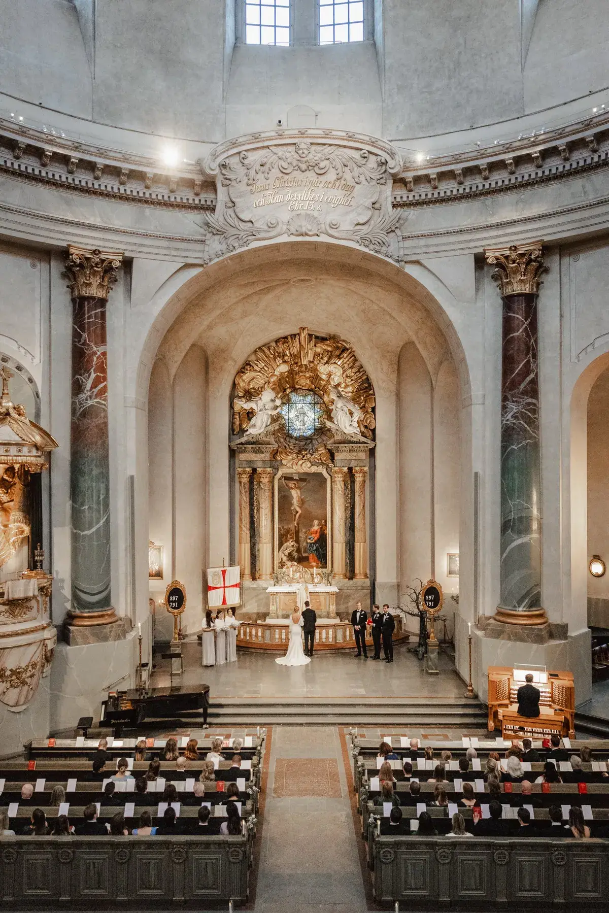 A wedding ceremony inside an ornate church.