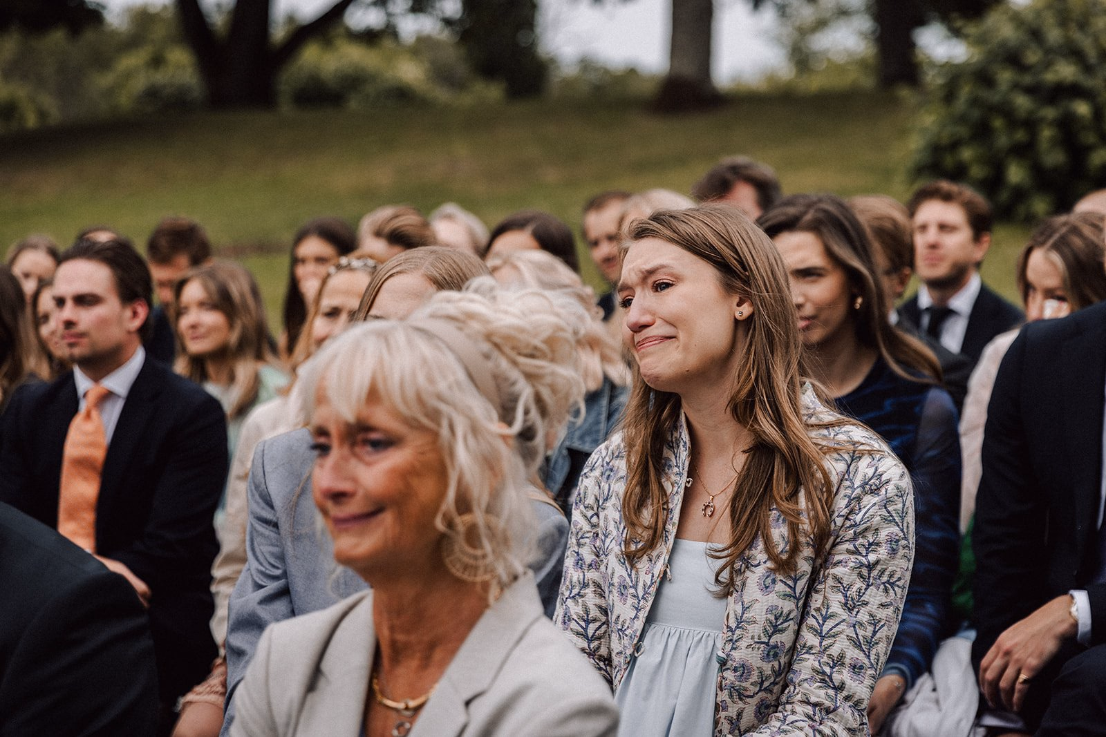 Guests watching an outdoor wedding ceremony