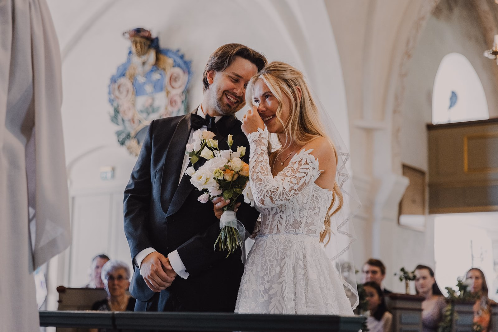 Bride and groom smiling during their church ceremony