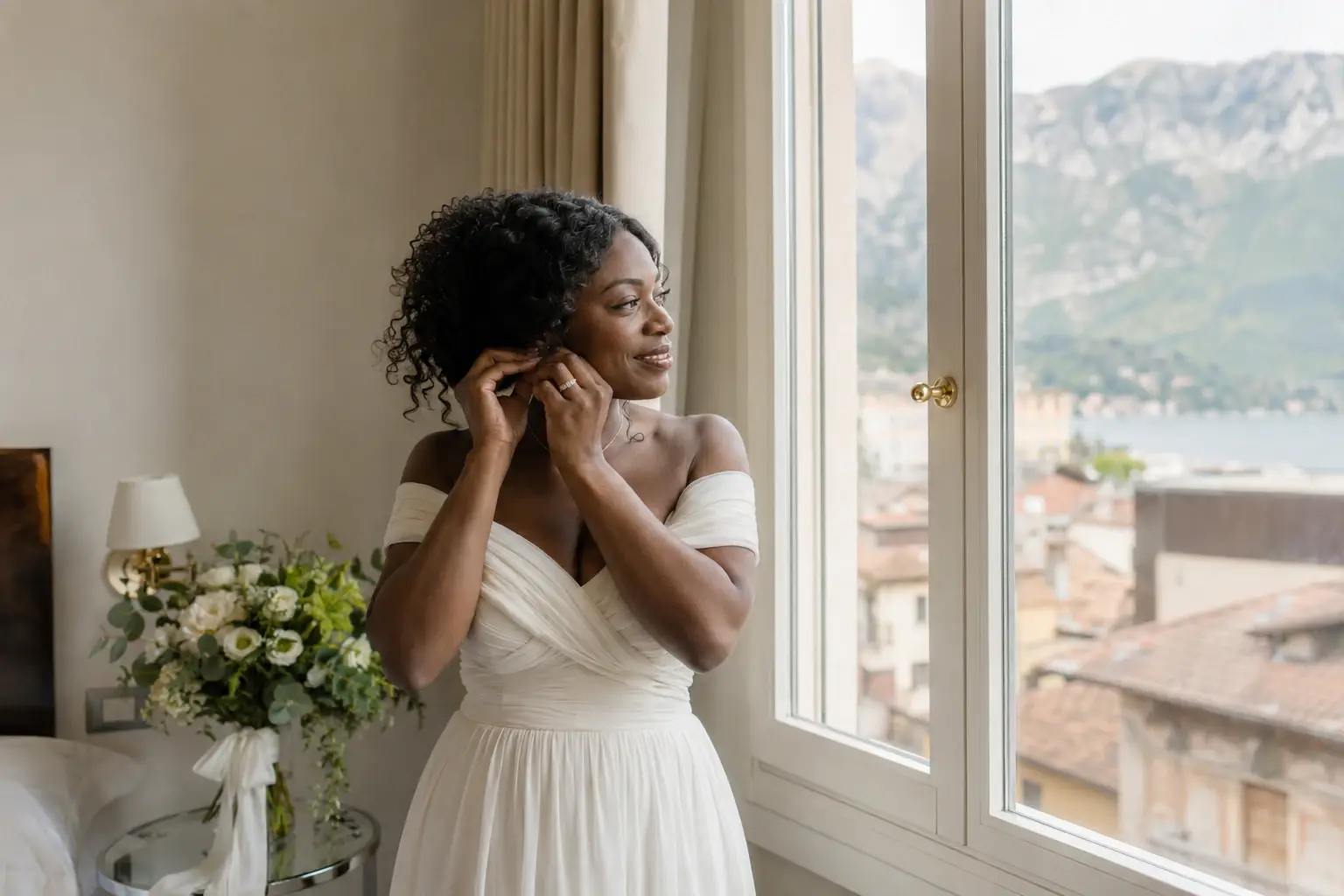 Bride getting ready in Riva del Garda with panoramic views of Lake Garda and the surrounding mountains before her wedding ceremony.
