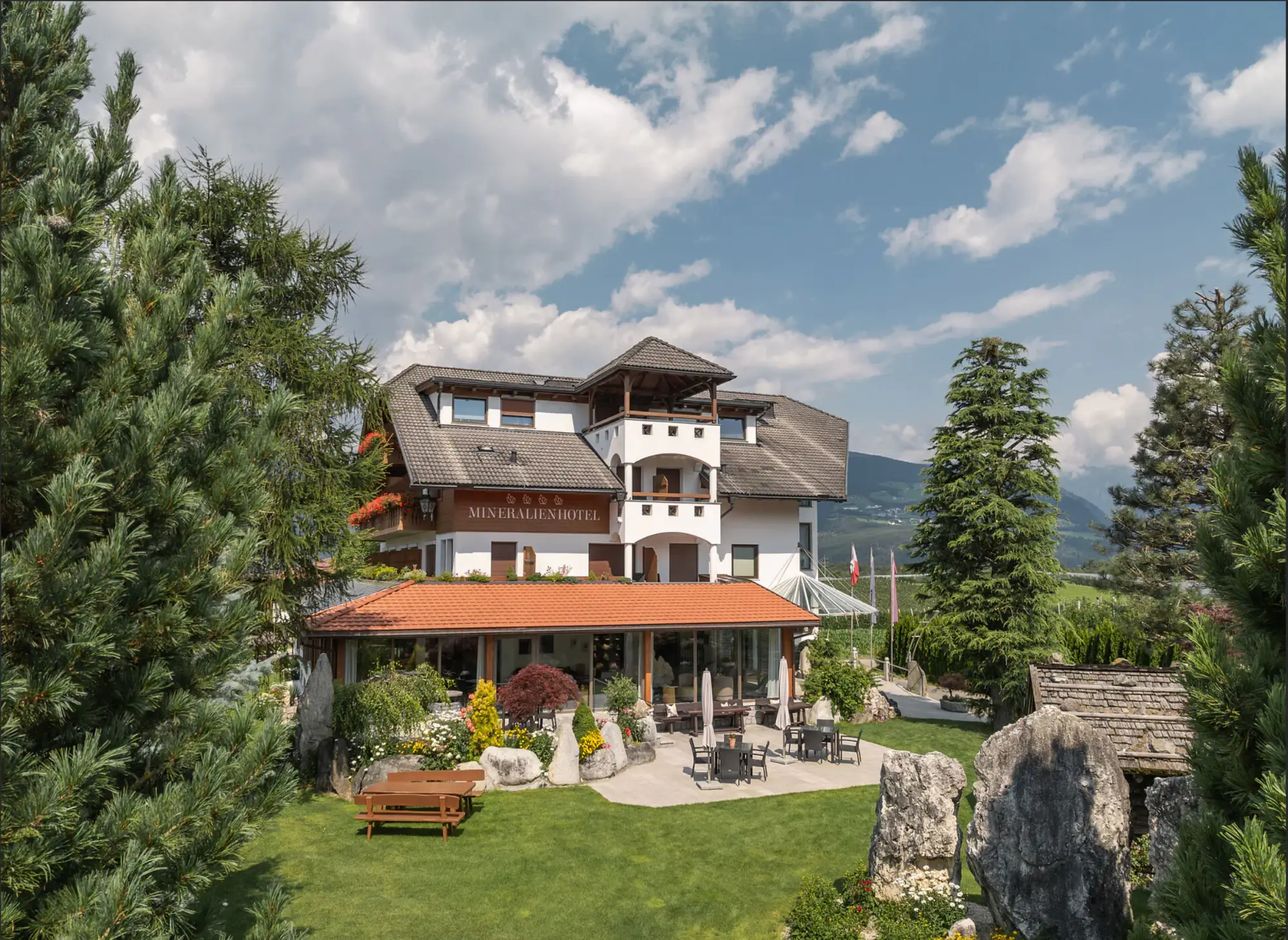 Mountain villa with landscaped grounds and outdoor seating.