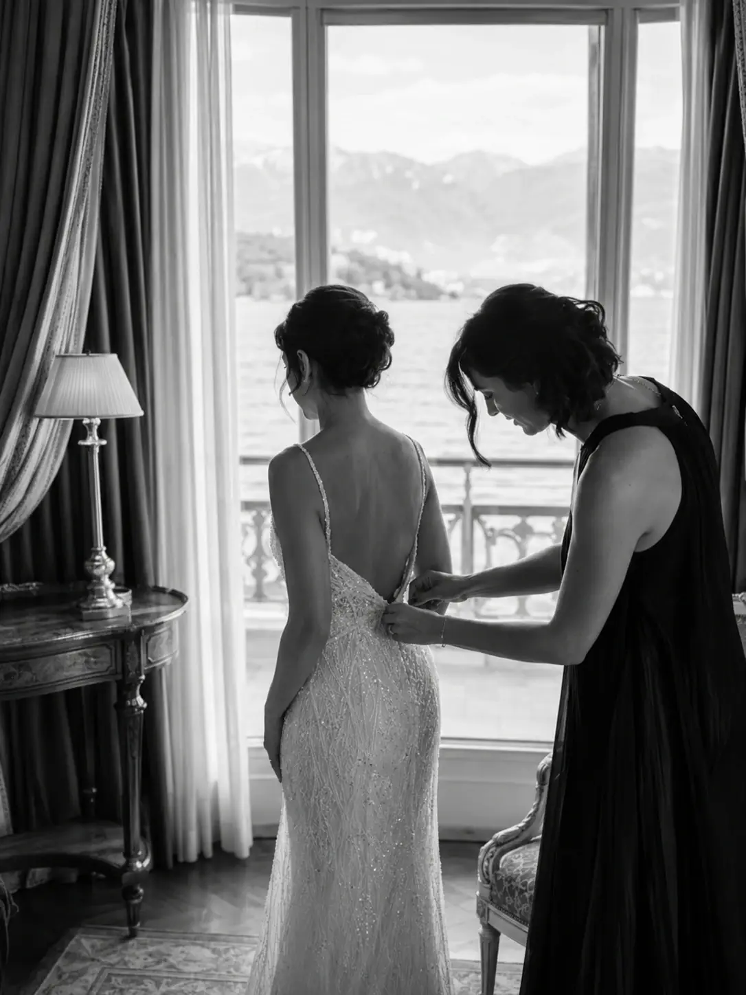Black and white getting ready moment at Grand Hotel Tremezzo with groom adjusting his tie before the Lake Como wedding ceremony.