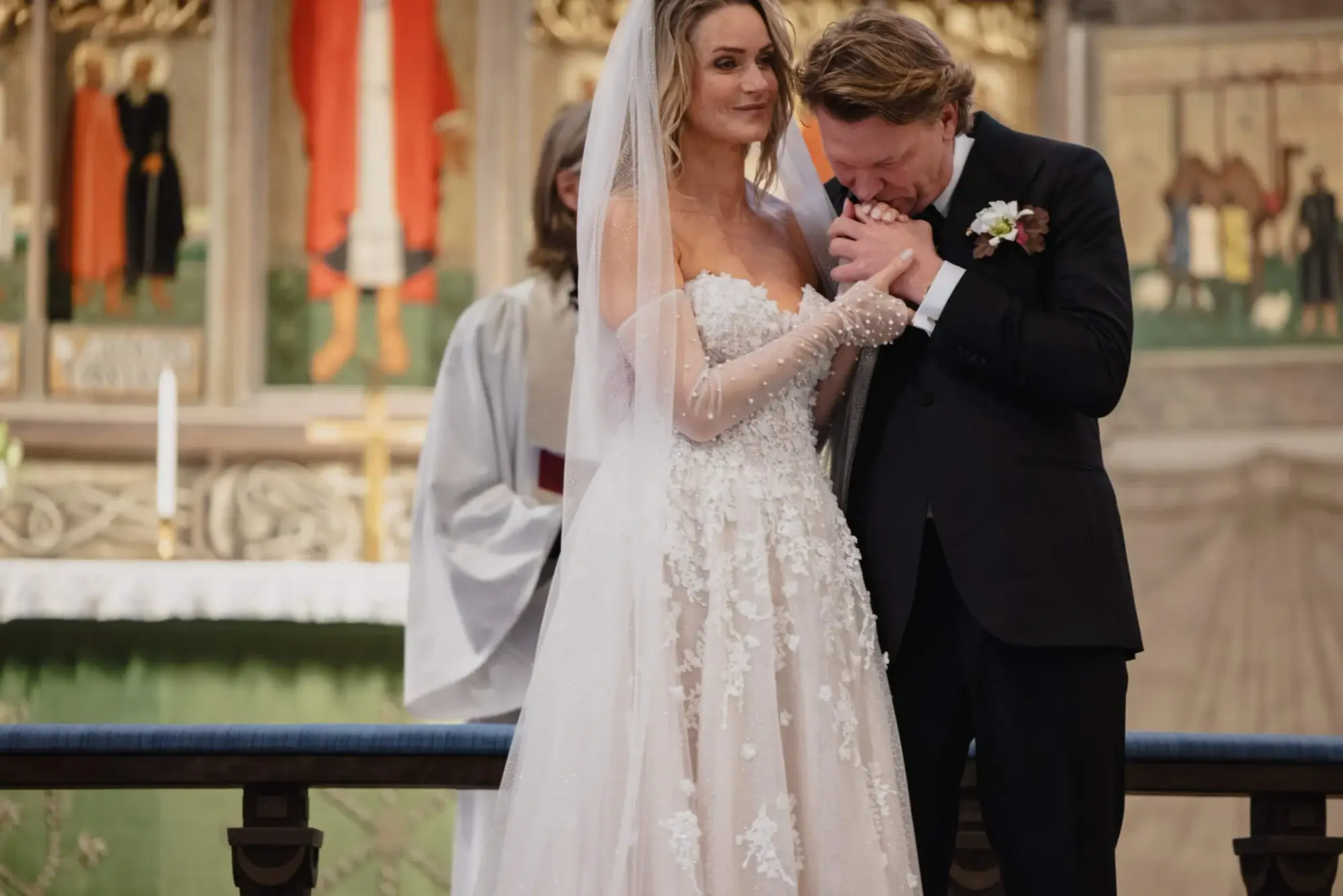 Bride and groom sharing an emotional moment during a church ceremony.