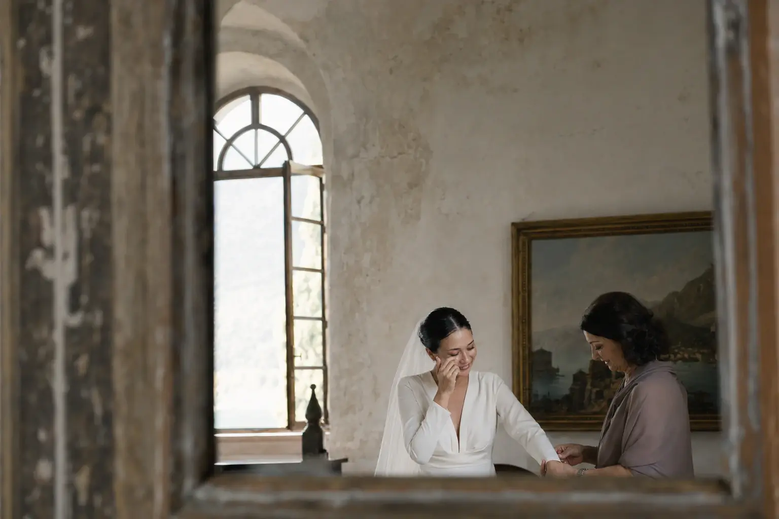 Bride getting ready with her mother before an Italian destination wedding, a meaningful moment often captured by a second wedding photographer