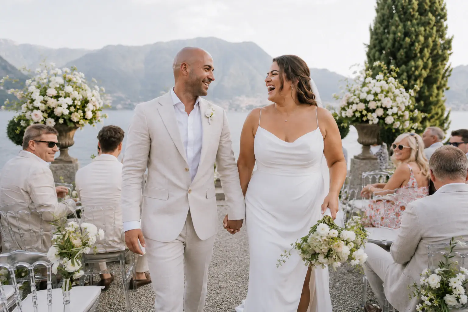 Couple smiling during an outdoor ceremony beside Lake Como.