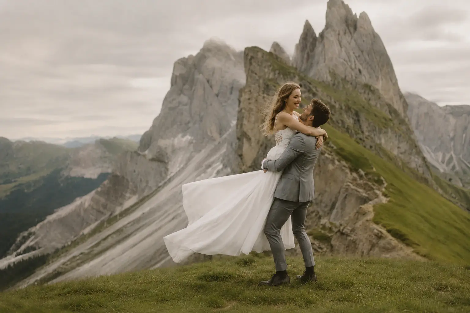 Bride and groom embracing on the mountain ridges of Seceda in Val Gardena.
