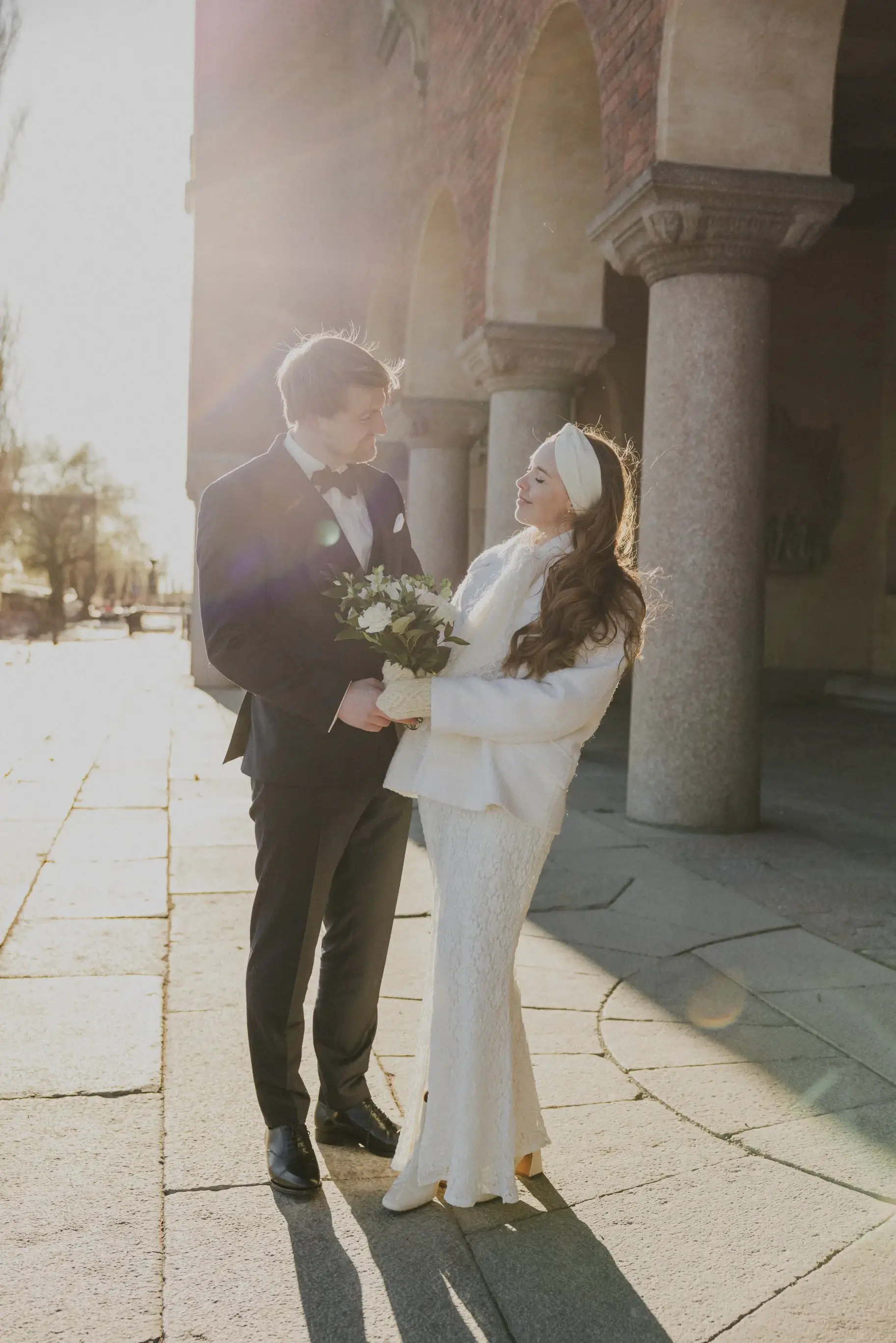 Couple walking together through the Stockholm City Hall arcade.