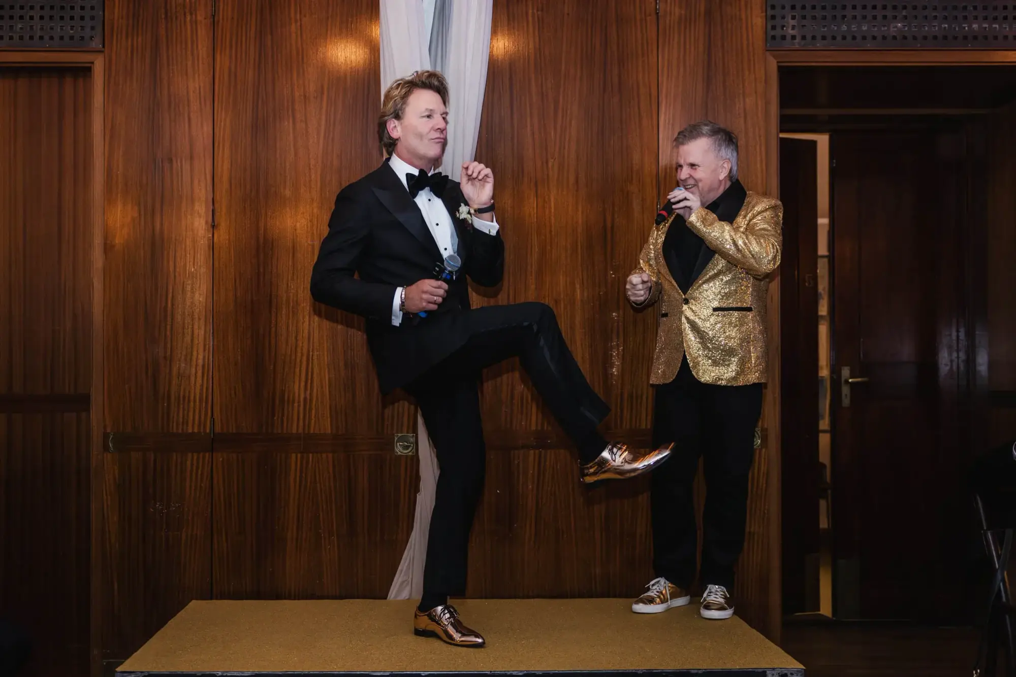 Groom dancing with a member of Herreys during a surprise golden-shoes performance at Café Opera