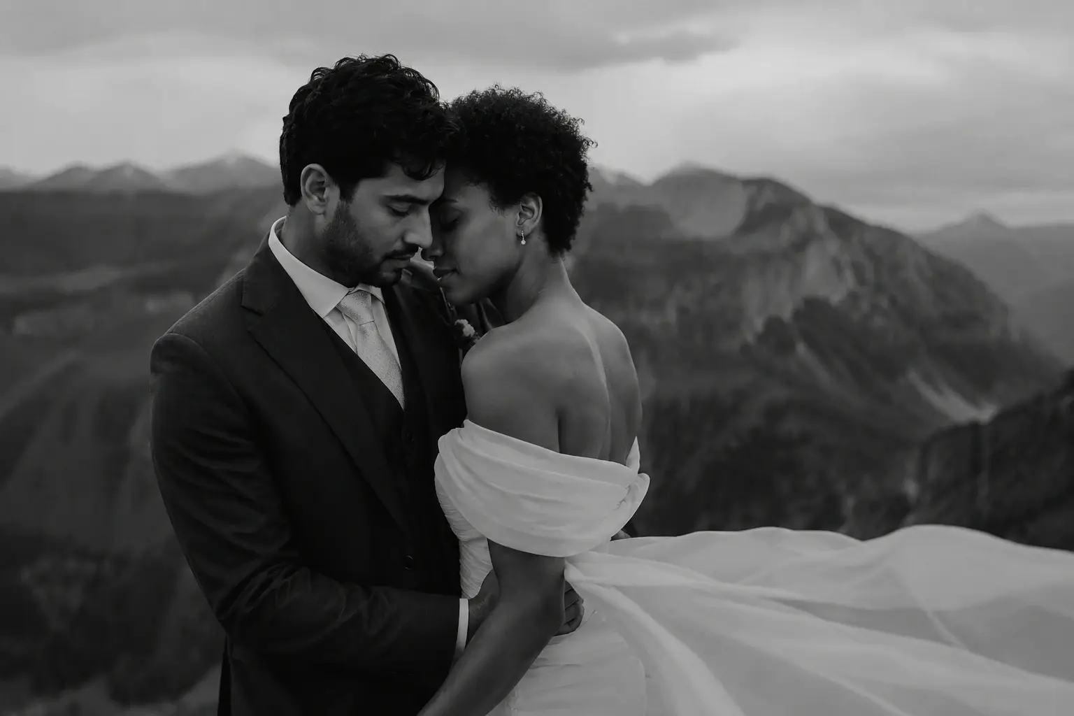 Bride and groom sharing an intimate portrait in the Dolomites with dramatic alpine mountains in the background.