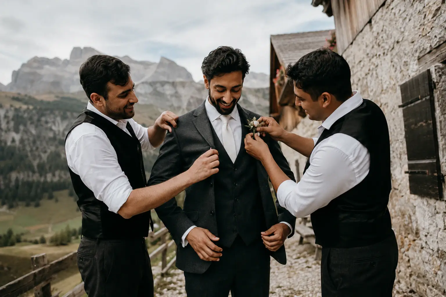 Groom getting ready with his groomsmen at a mountain chalet in the Dolomites before an intimate wedding ceremony.