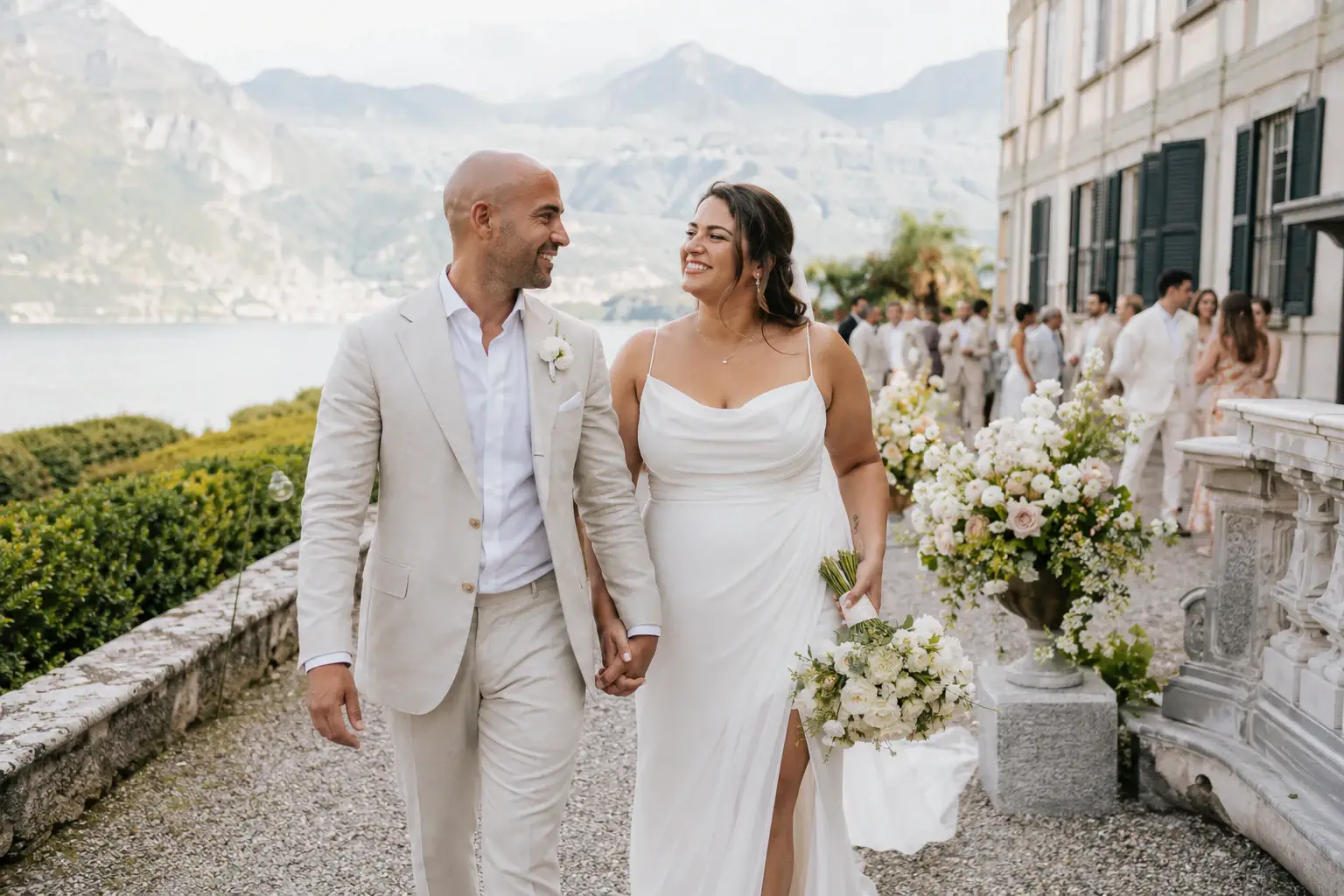 Newlyweds walking from their lakeside ceremony.