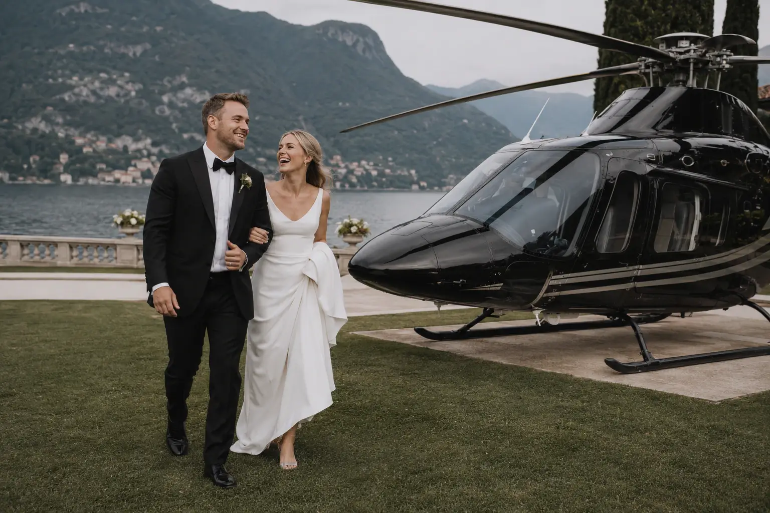 Newlyweds walking beside a helicopter overlooking Lake Como.