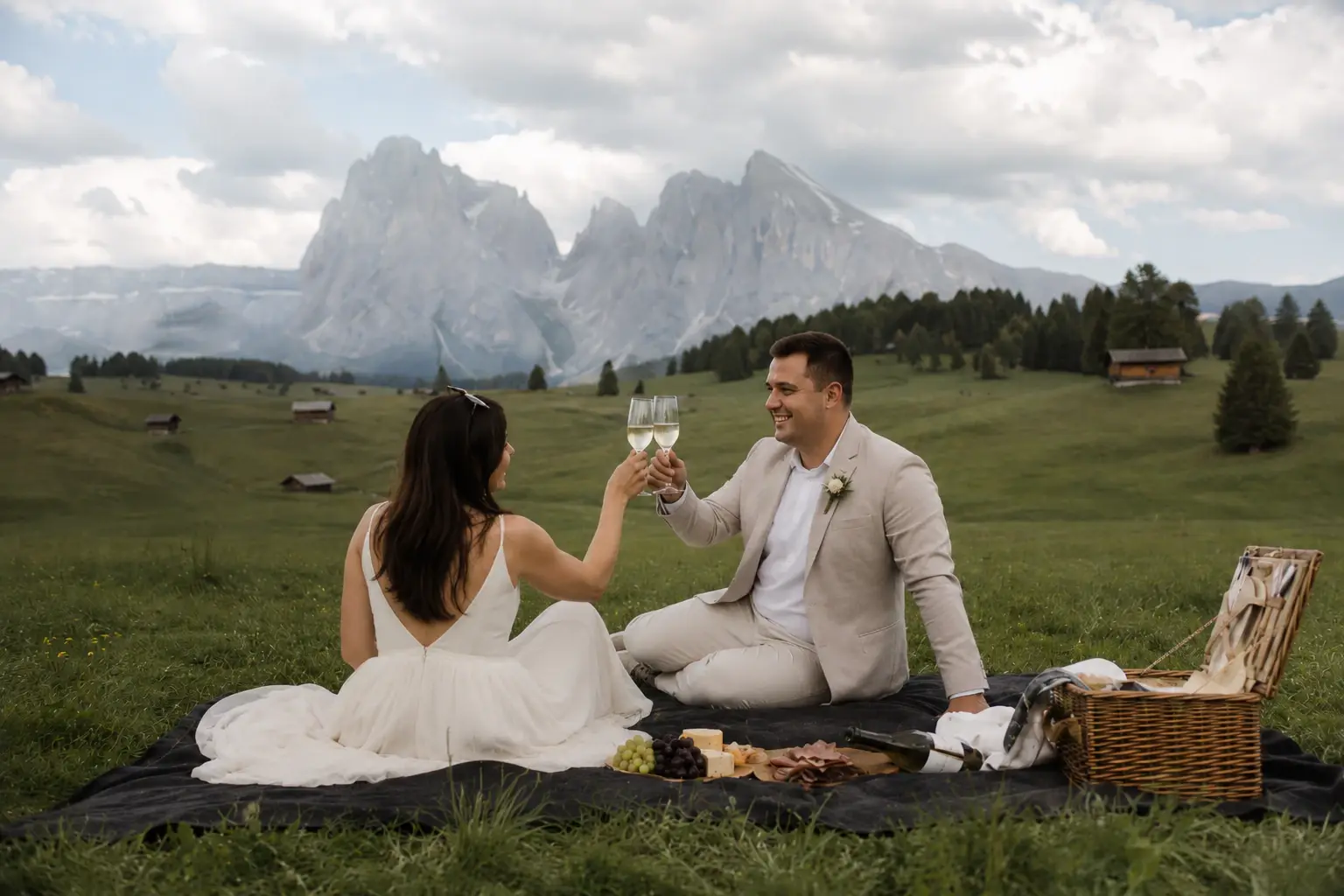Couple sharing a picnic in a Dolomites meadow.