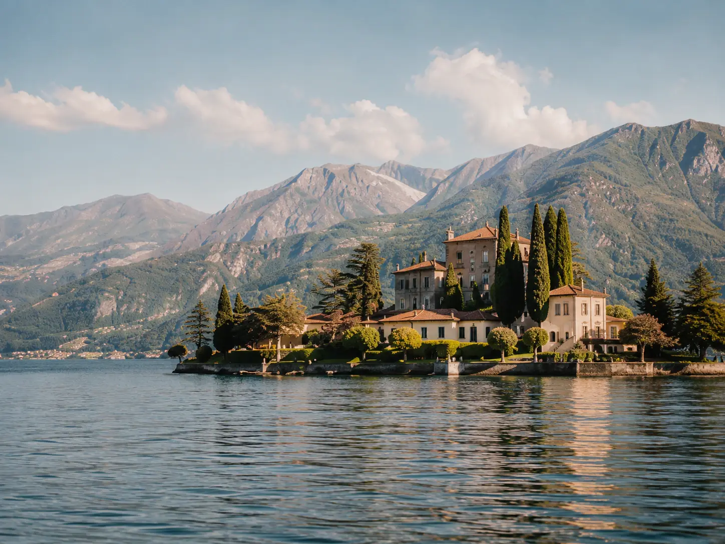 Lakeside destination wedding ceremony setup in Italy with mountain views