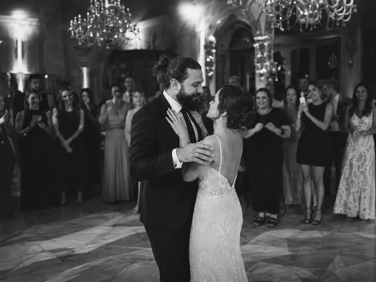 “Grand Hotel Tremezzo first dance during elegant black and white wedding reception with emotional evening atmosphere and guests watching in Lake Como”
