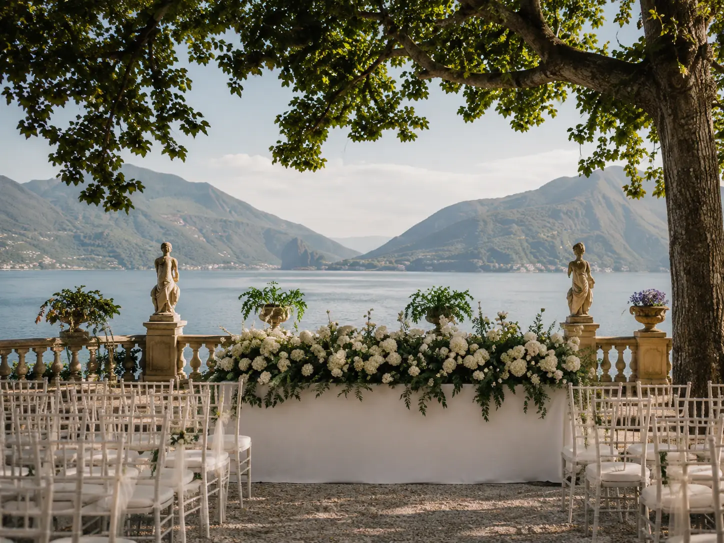 Lake Como style villa terrace with classical statue and mountain lake view
