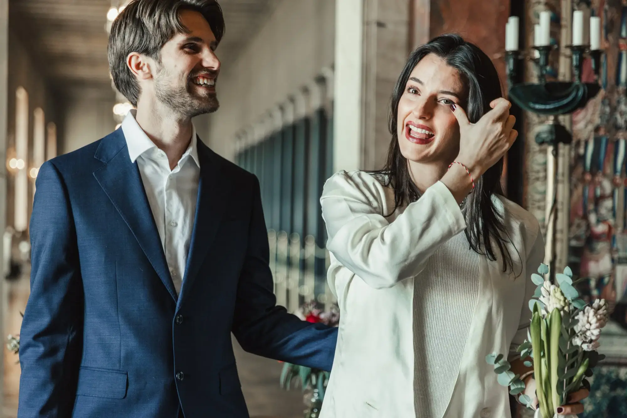 Couple laughing together indoors after their civil ceremony.