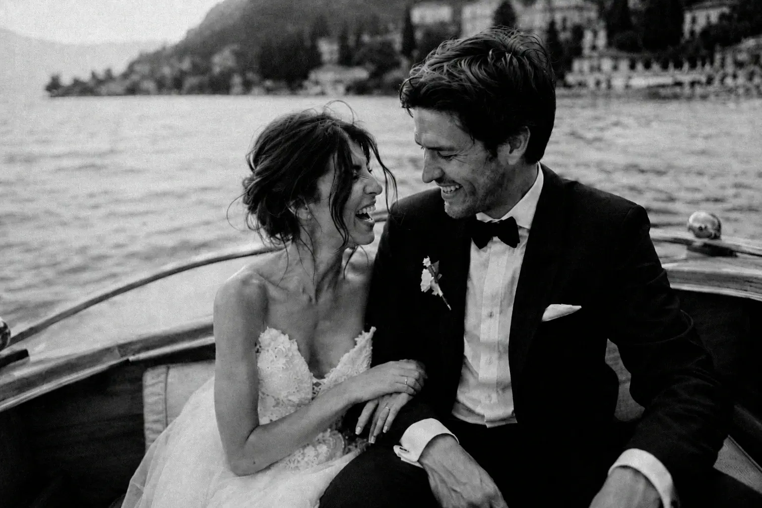 Black-and-white portrait of newlyweds on a boat.
