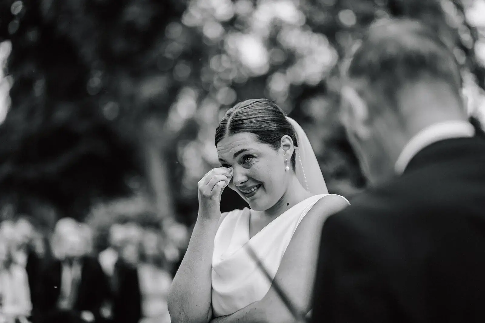 Emotional bride during an outdoor wedding ceremony.