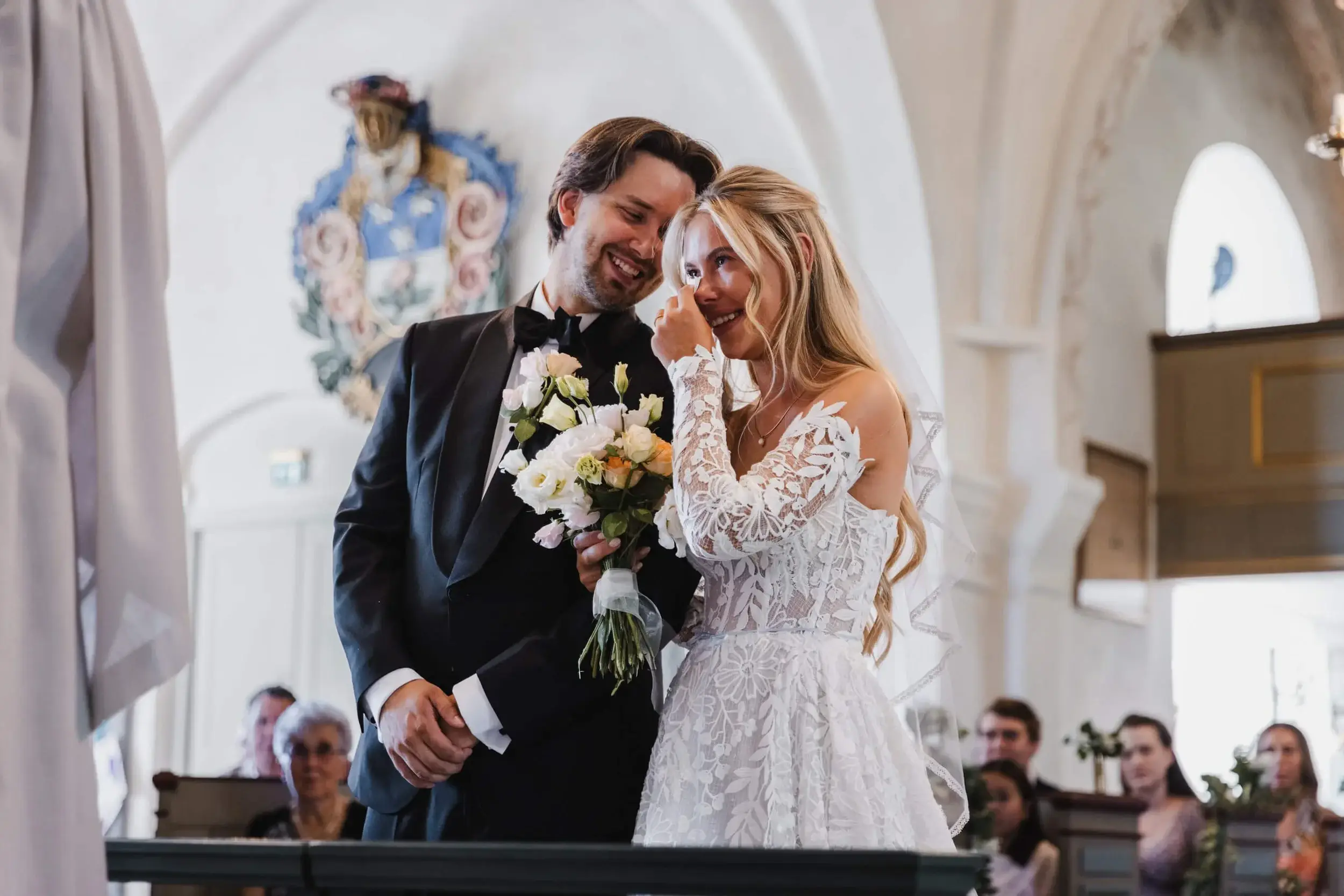 Newlyweds sharing an emotional moment during a church ceremony.